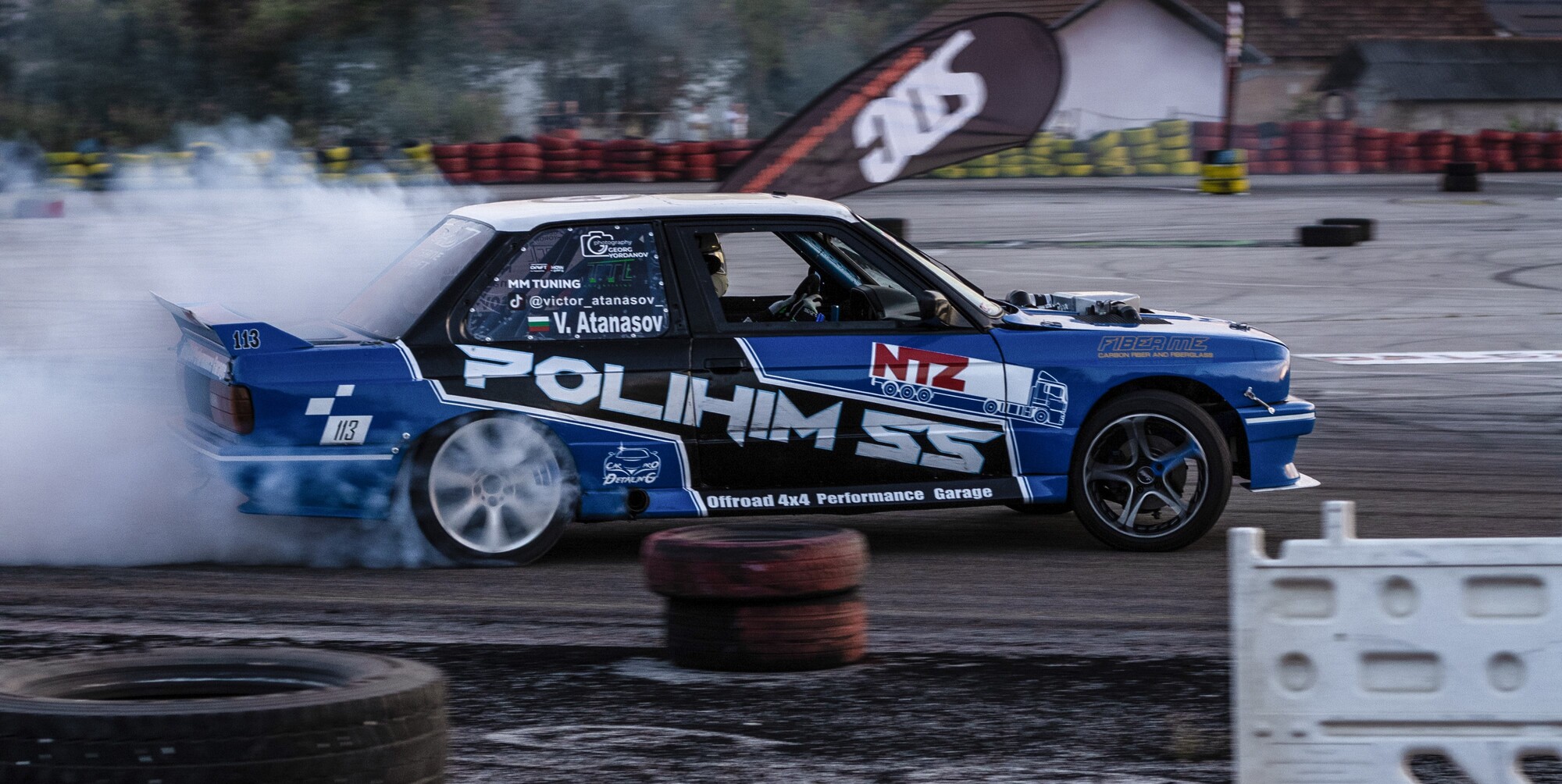 Car drifting with smoke from tires and leaves in the background at SDC Drift, by Vojislav Zivkovic aka Vojke Photo